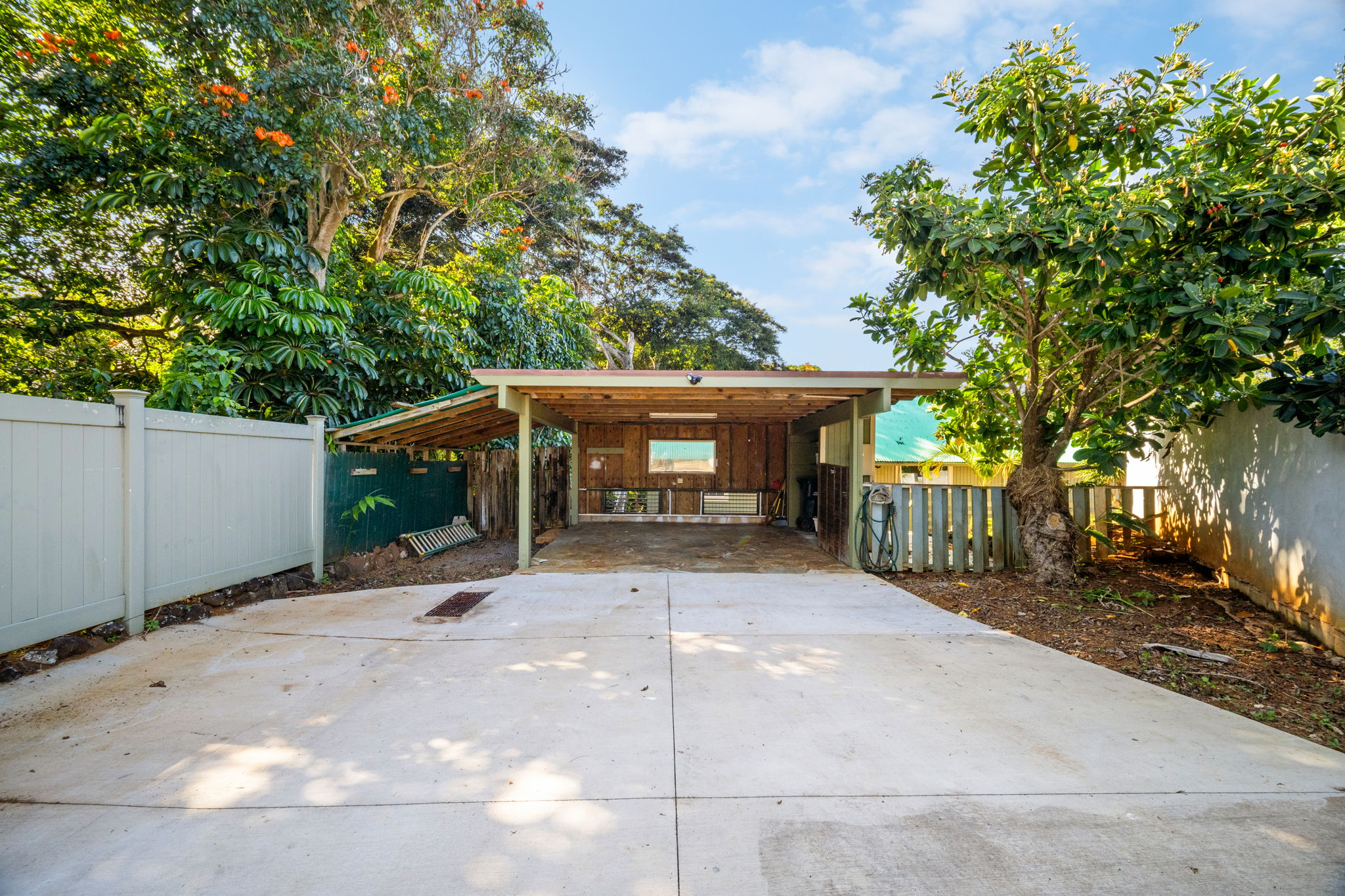 6050 C Kapahi Road Kapaa, HI 96746 - Photo 11 of 30 a front view of a house with a yard and garage
