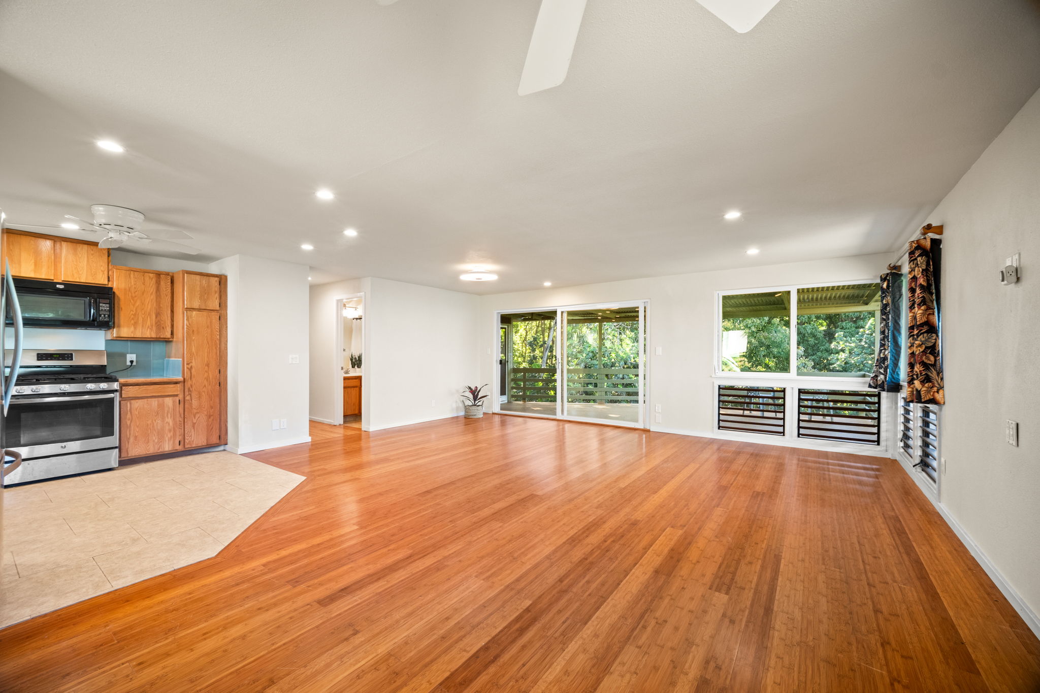 6050 C Kapahi Road Kapaa, HI 96746 - Photo 2 of 30 a view of empty room with wooden floor and windows