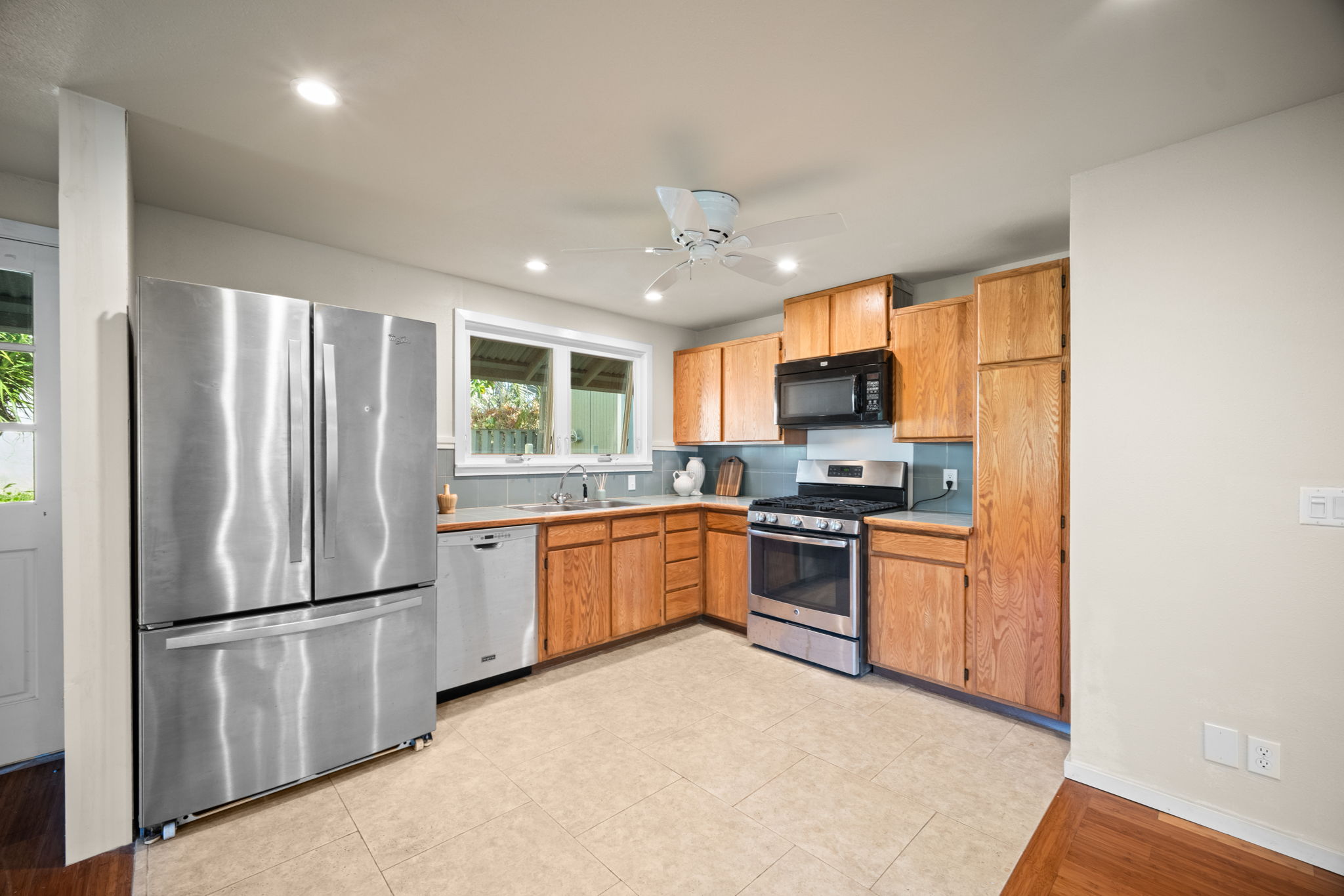 6050 C Kapahi Road Kapaa, HI 96746 - Photo 3 of 30 a kitchen with granite countertop stainless steel appliances and refrigerator