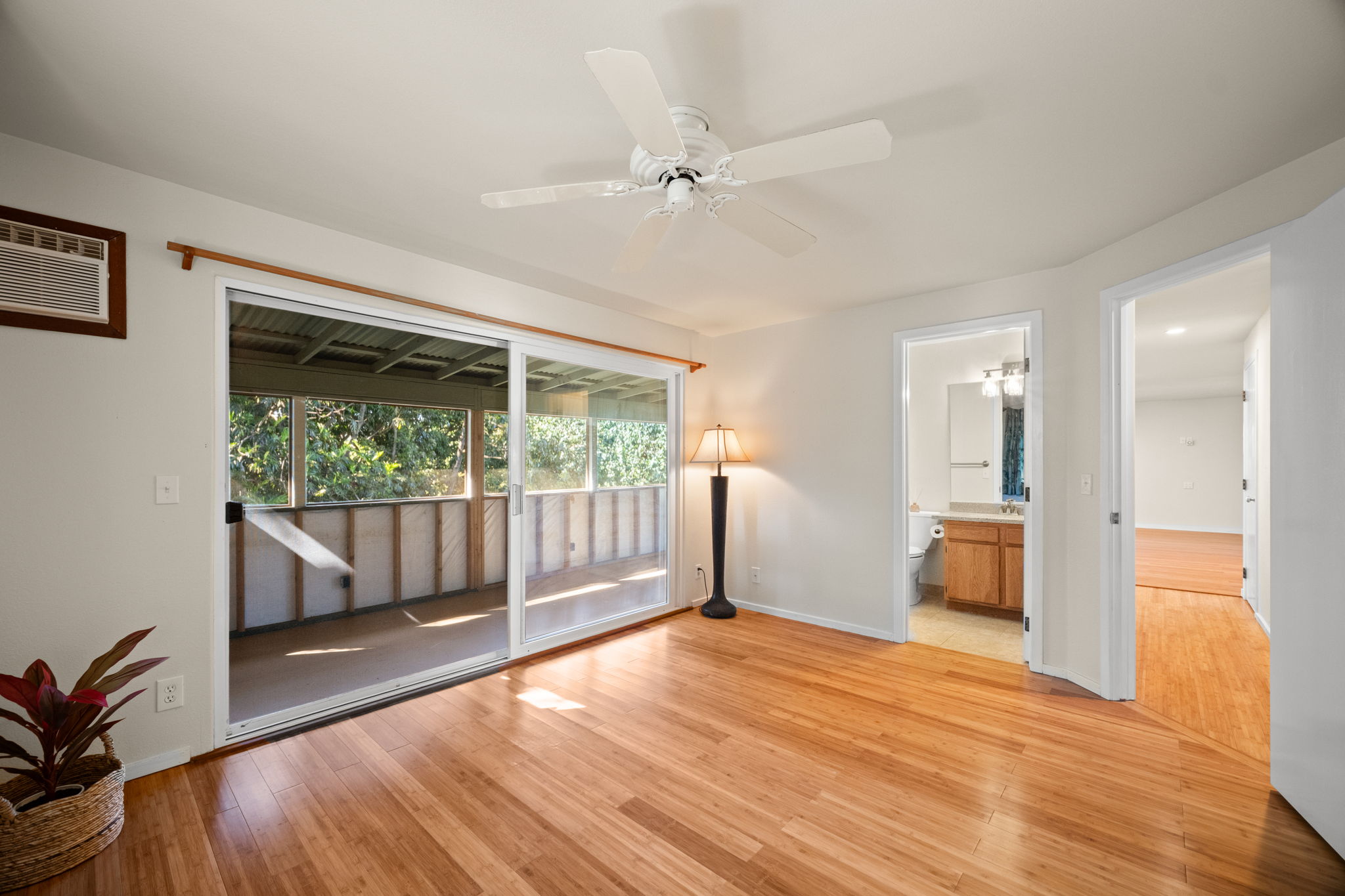 6050 C Kapahi Road Kapaa, HI 96746 - Photo 6 of 30 a view of an empty room with wooden floor and a window
