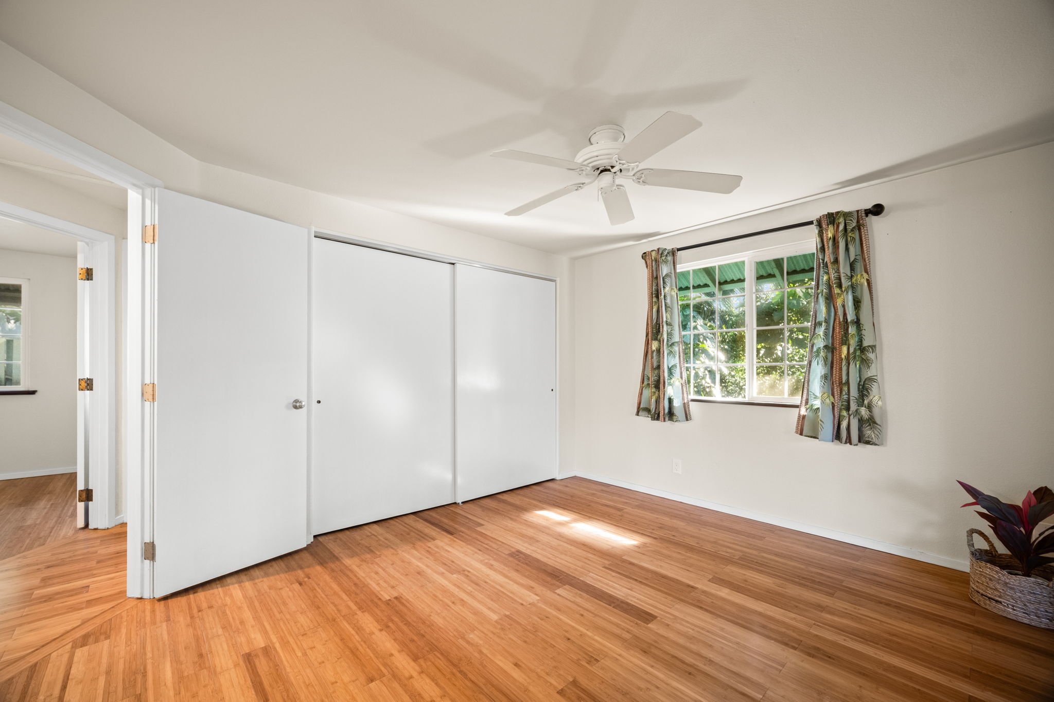 6050 C Kapahi Road Kapaa, HI 96746 - Photo 8 of 30 a view of empty room with wooden floor and fan