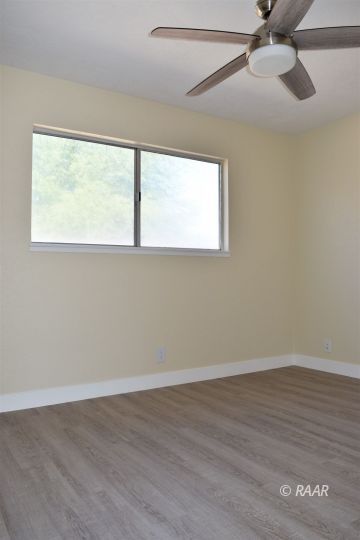 718 West Haloid Avenue Ridgecrest, CA 93555 - Photo 15 of 24 a view of an empty room with wooden floor and a window