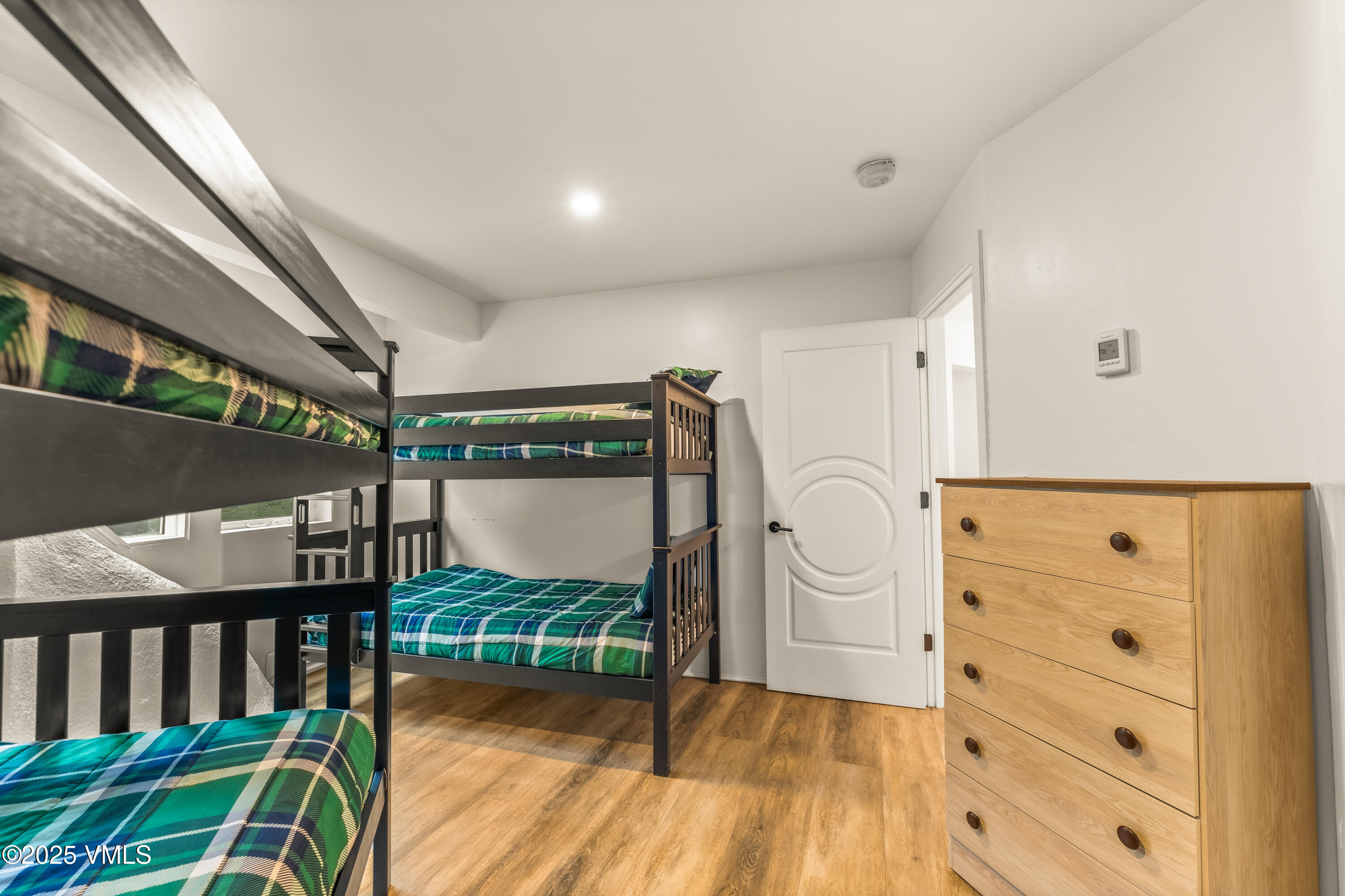 2940 Basingdale Boulevard, Unit 2 Vail, CO 81657 - Photo 16 of 28 a bedroom with furniture and a wooden floor