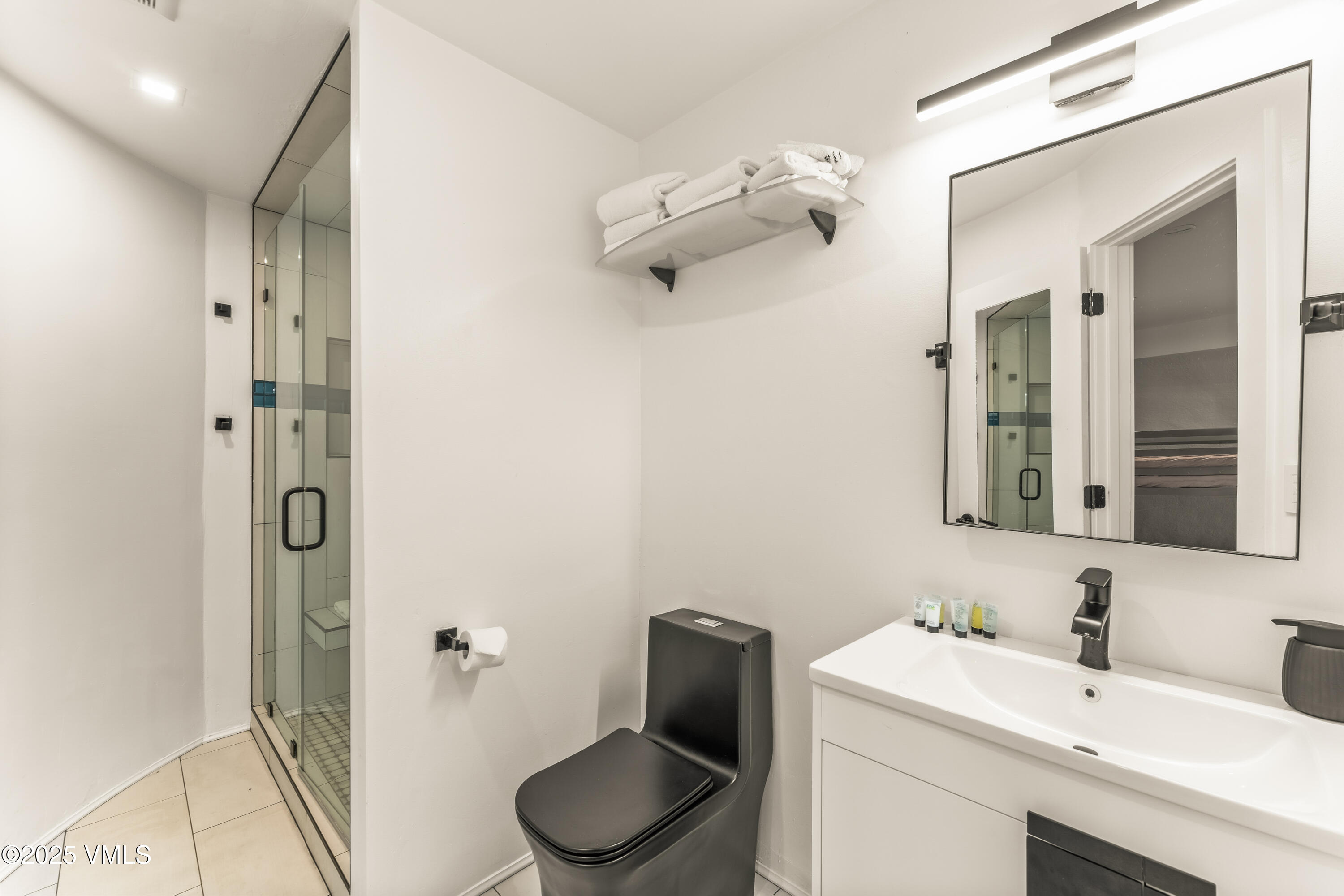 2940 Basingdale Boulevard, Unit 2 Vail, CO 81657 - Photo 17 of 28 a bathroom with a sink vanity mirror and toilet