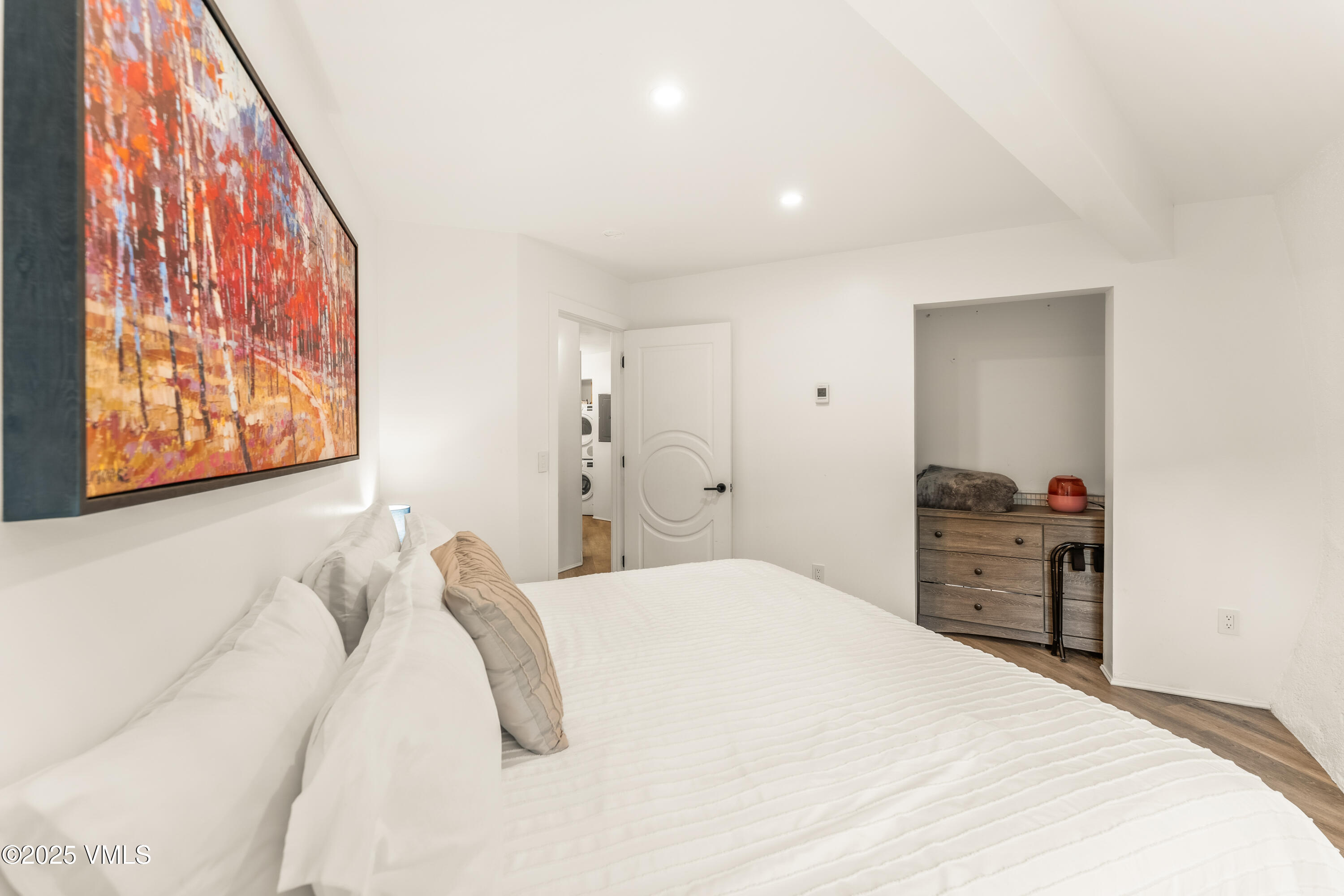 2940 Basingdale Boulevard, Unit 2 Vail, CO 81657 - Photo 18 of 28 a bedroom with a bed and a painting on the wall