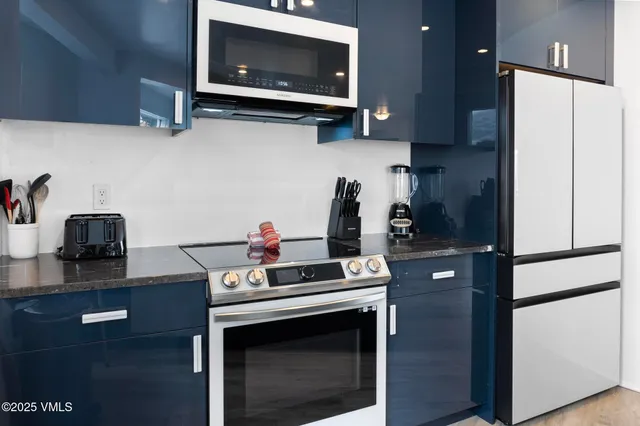 a living room with furniture a flat screen tv and a floor to ceiling window