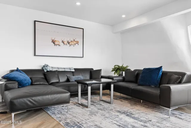 a bedroom with furniture and a wooden floor