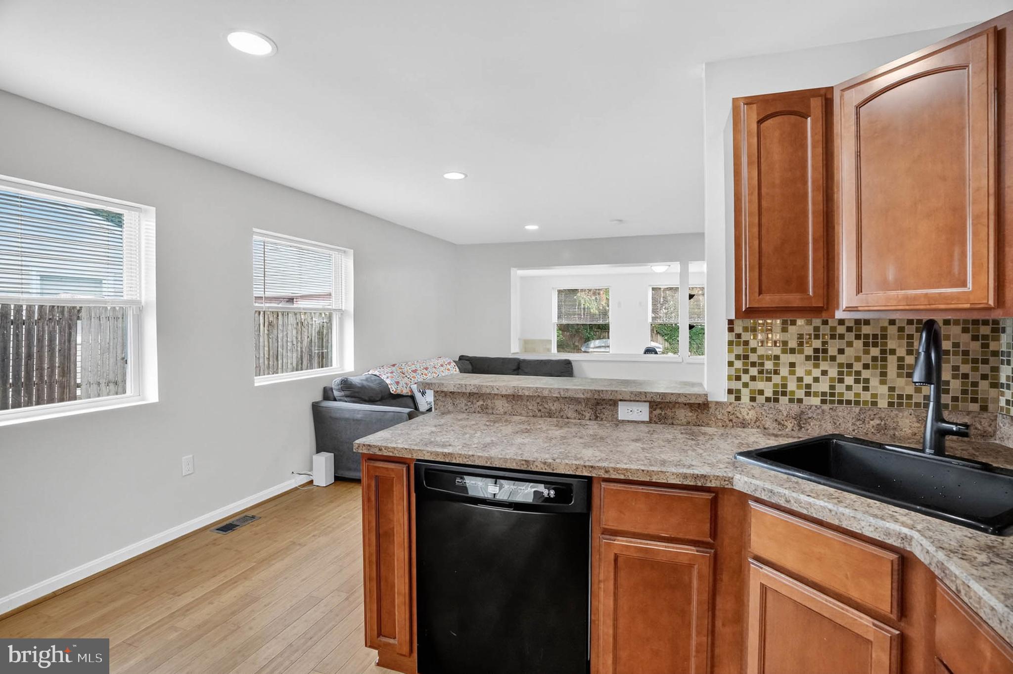 1307 2nd Road Baltimore, MD 21220 - Photo 24 of 25 a kitchen with stainless steel appliances granite countertop a sink stove and cabinets