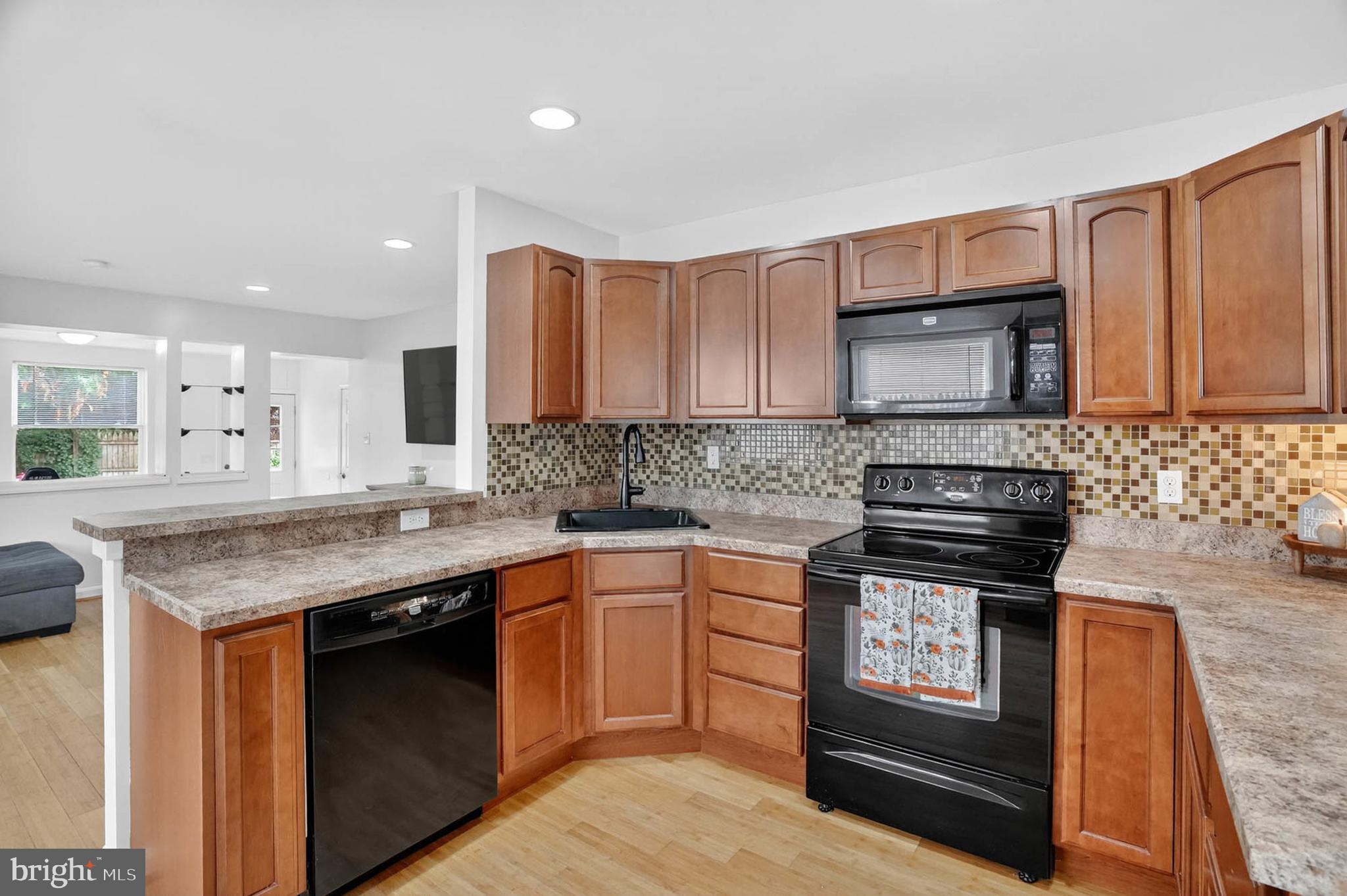 1307 2nd Road Baltimore, MD 21220 - Photo 8 of 25 a kitchen with stainless steel appliances granite countertop a stove a sink and a microwave