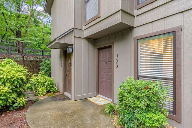 front view of a house with potted plants