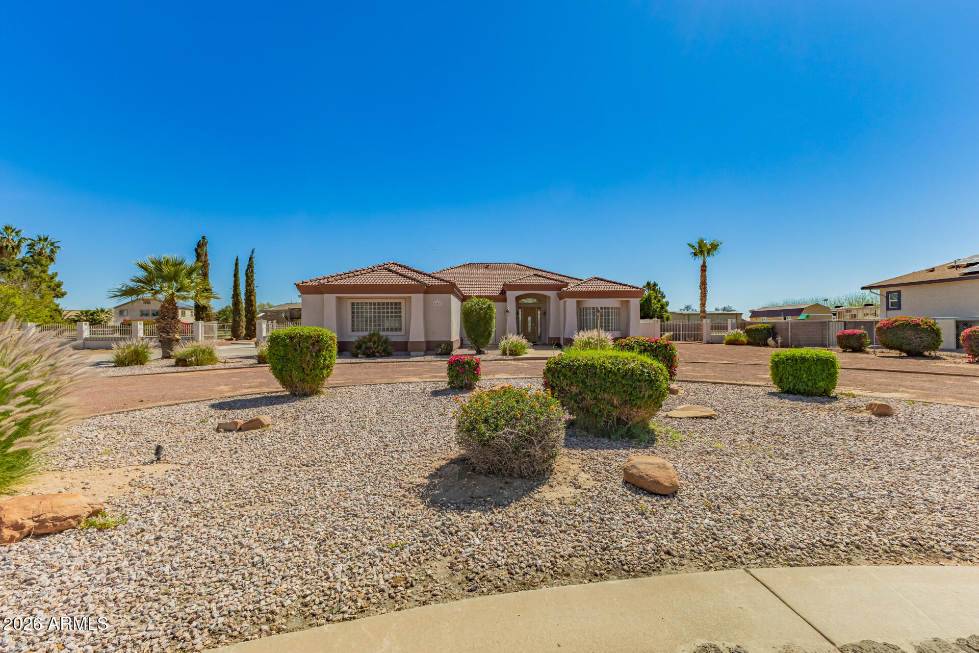 16037 West Wade Lane Goodyear, AZ 85338 - Photo 1 of 67 a front view of a house with garden