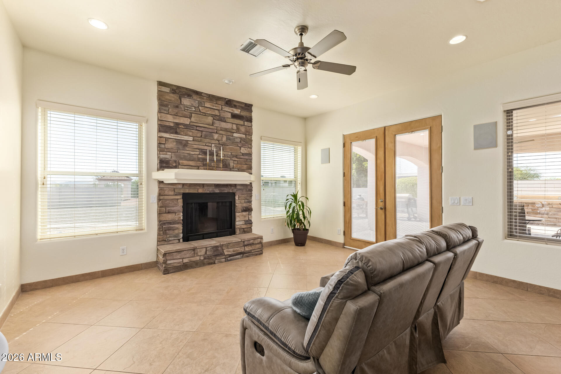 16037 West Wade Lane Goodyear, AZ 85338 - Photo 15 of 67 a living room with furniture and a fireplace