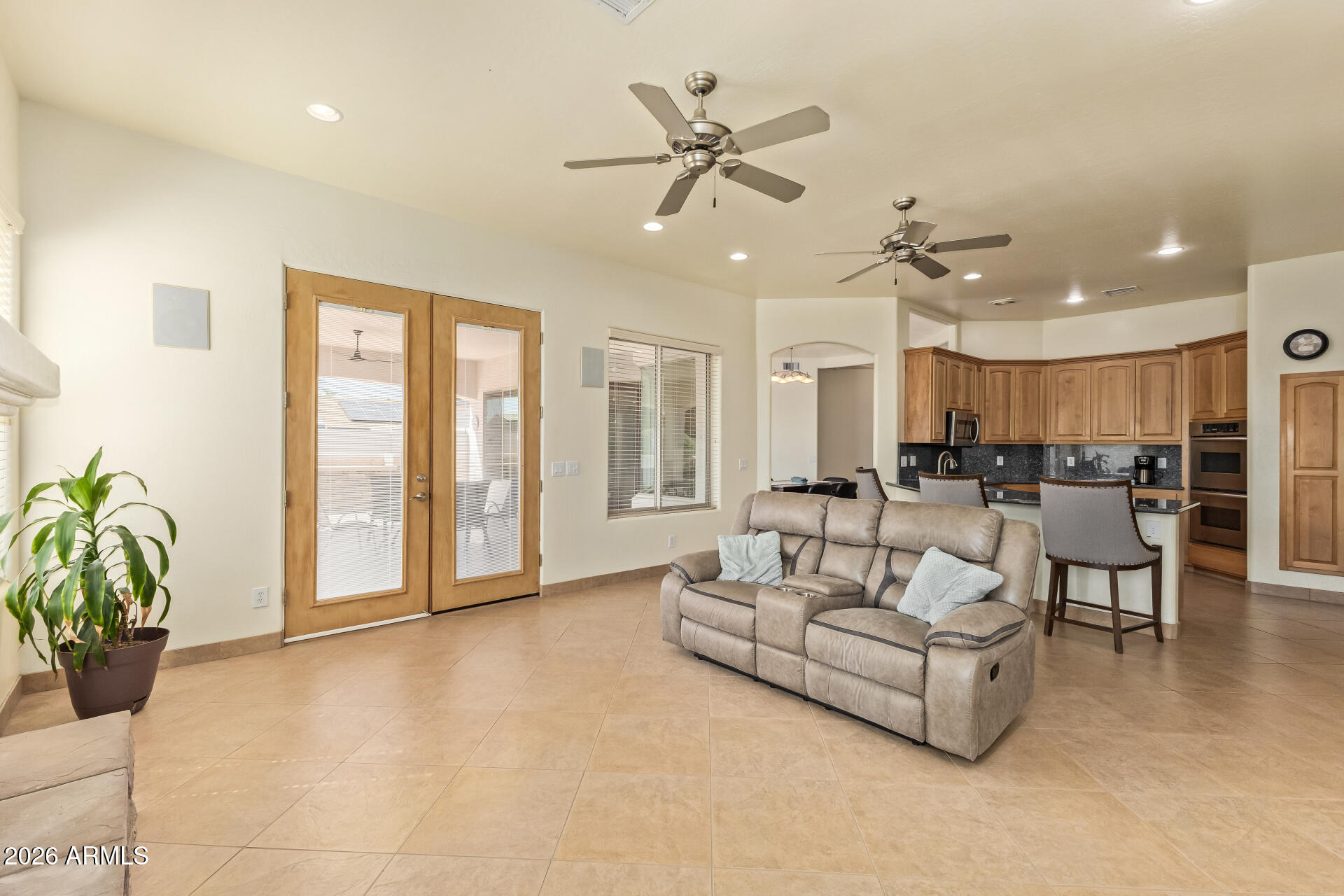 16037 West Wade Lane Goodyear, AZ 85338 - Photo 16 of 67 a living room with furniture and a large window
