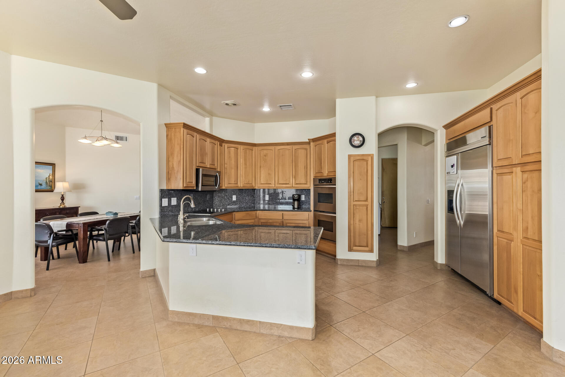 16037 West Wade Lane Goodyear, AZ 85338 - Photo 18 of 67 a kitchen with stainless steel appliances granite countertop a refrigerator and a stove