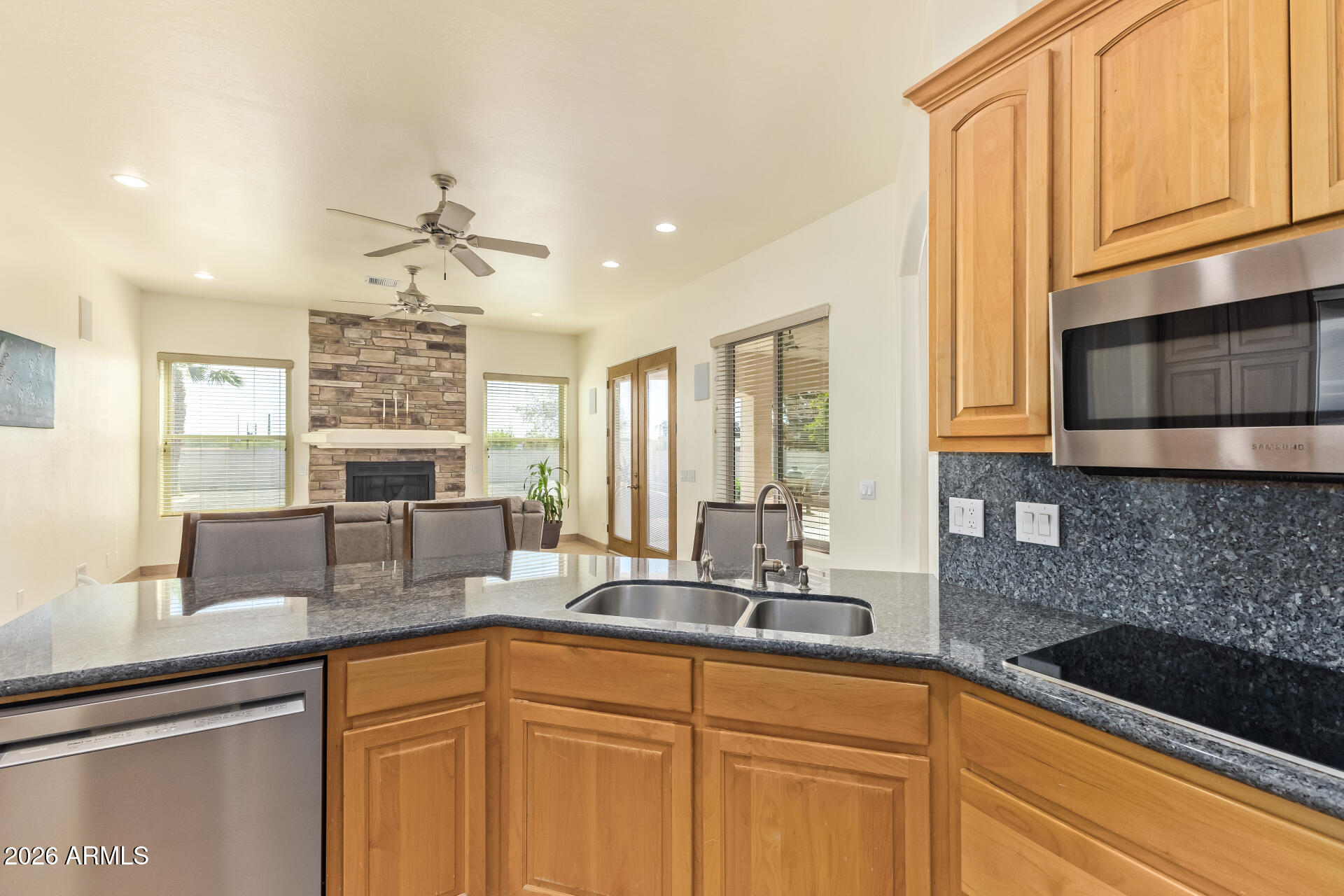 16037 West Wade Lane Goodyear, AZ 85338 - Photo 22 of 67 a kitchen with stainless steel appliances granite countertop a sink a stove and cabinets