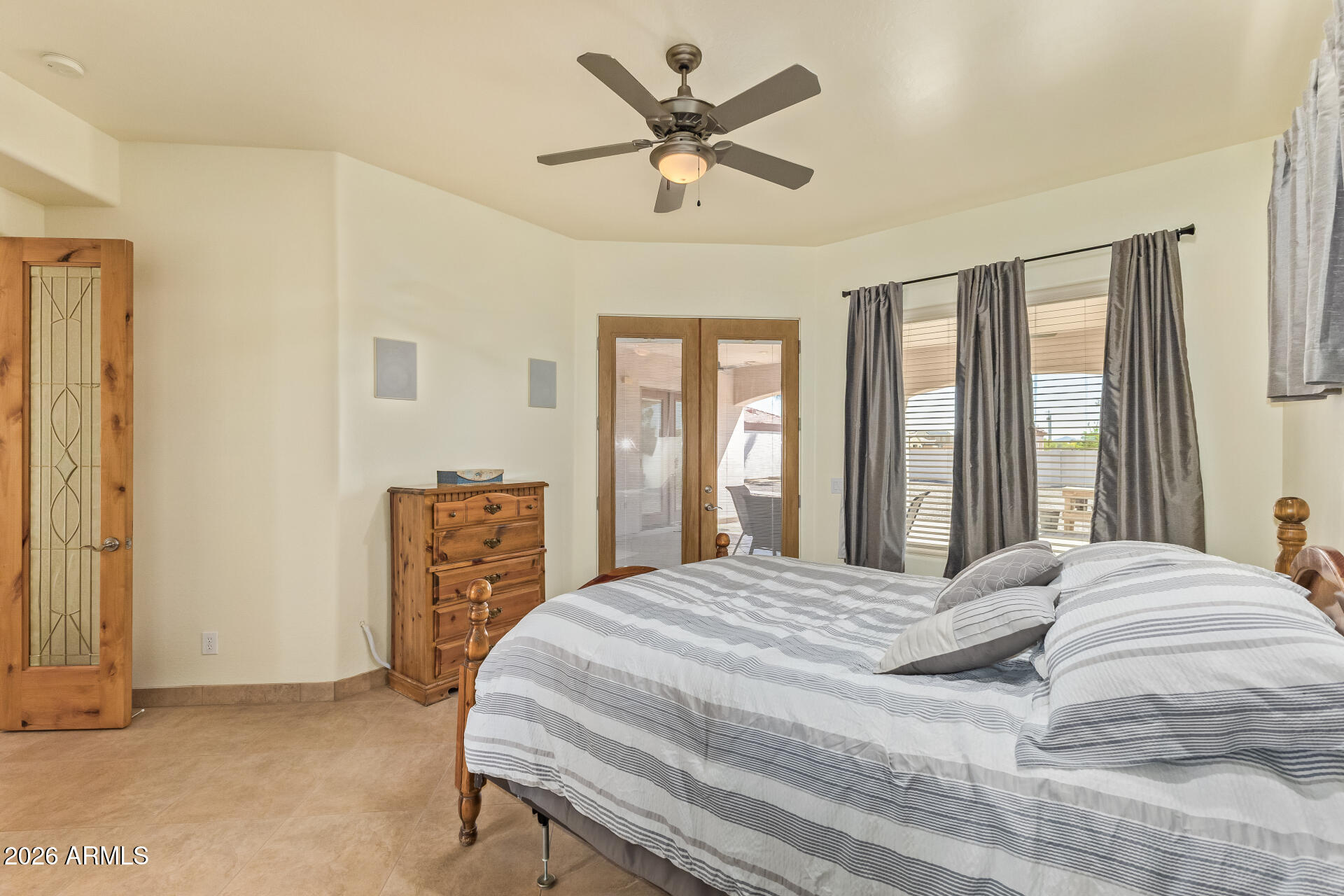 16037 West Wade Lane Goodyear, AZ 85338 - Photo 24 of 67 a bedroom with a bed and window