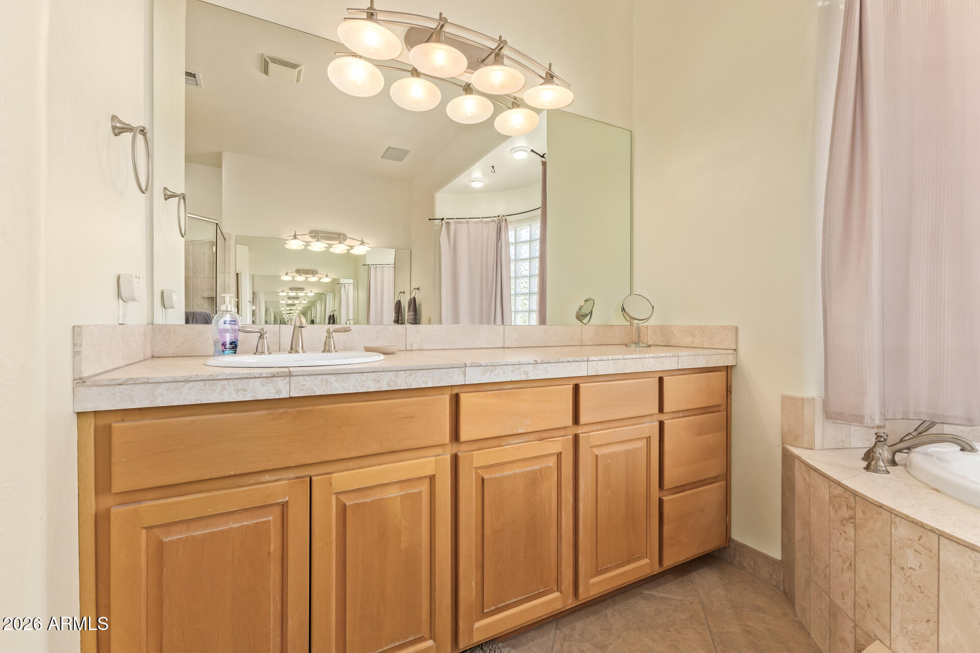 16037 West Wade Lane Goodyear, AZ 85338 - Photo 28 of 67 a bathroom with a double vanity sink mirror and double