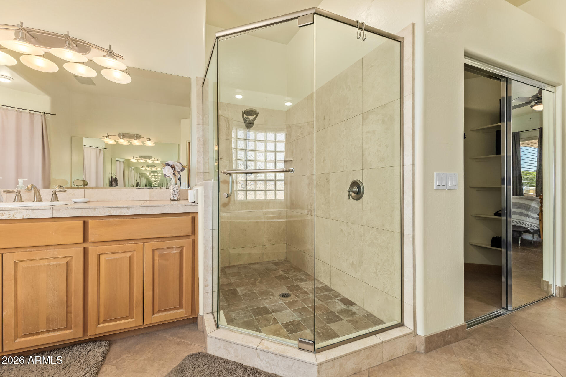16037 West Wade Lane Goodyear, AZ 85338 - Photo 29 of 67 a bathroom with a shower sink and mirror