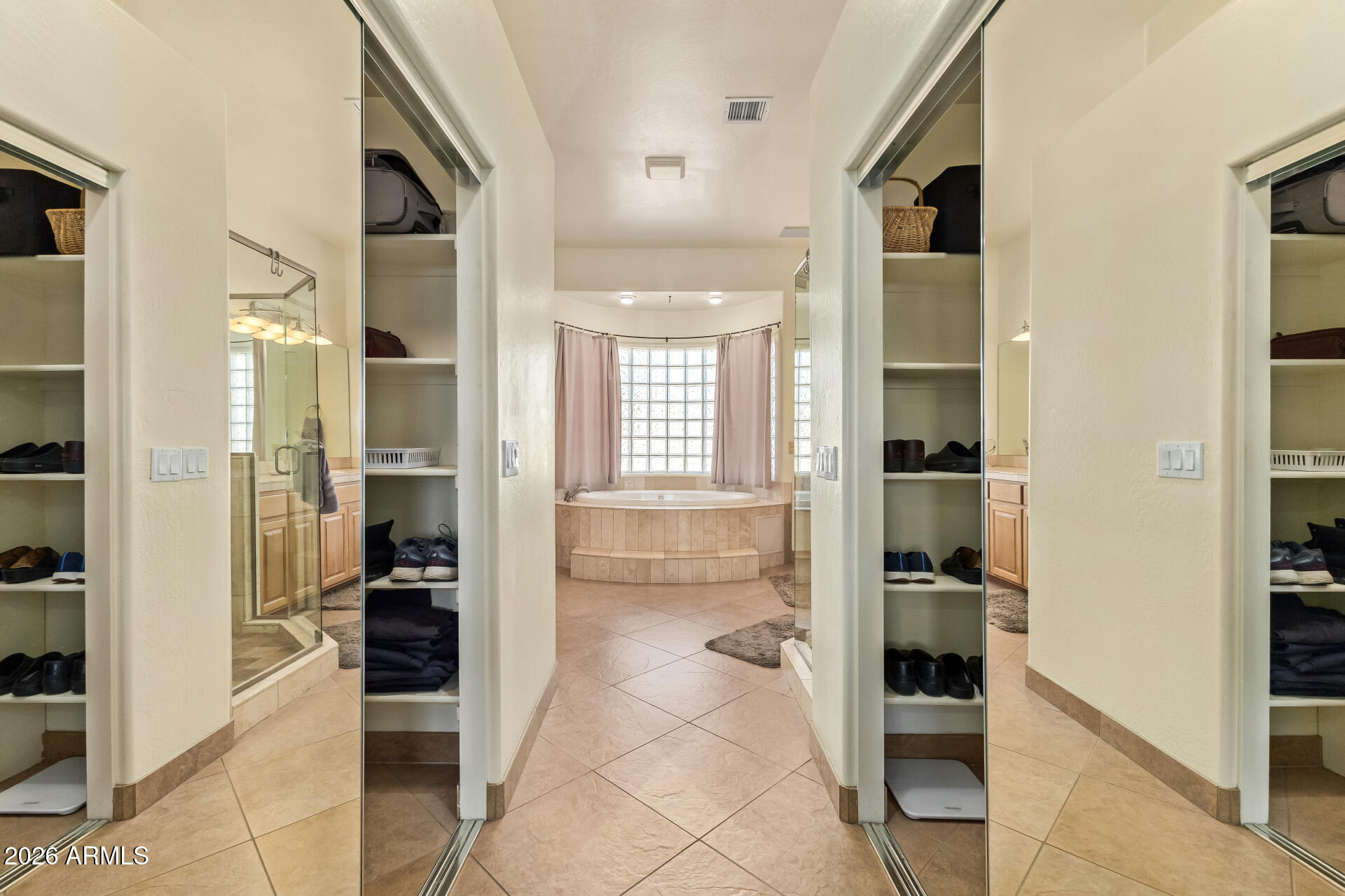16037 West Wade Lane Goodyear, AZ 85338 - Photo 30 of 67 a bathroom with a glass door shower and a sink
