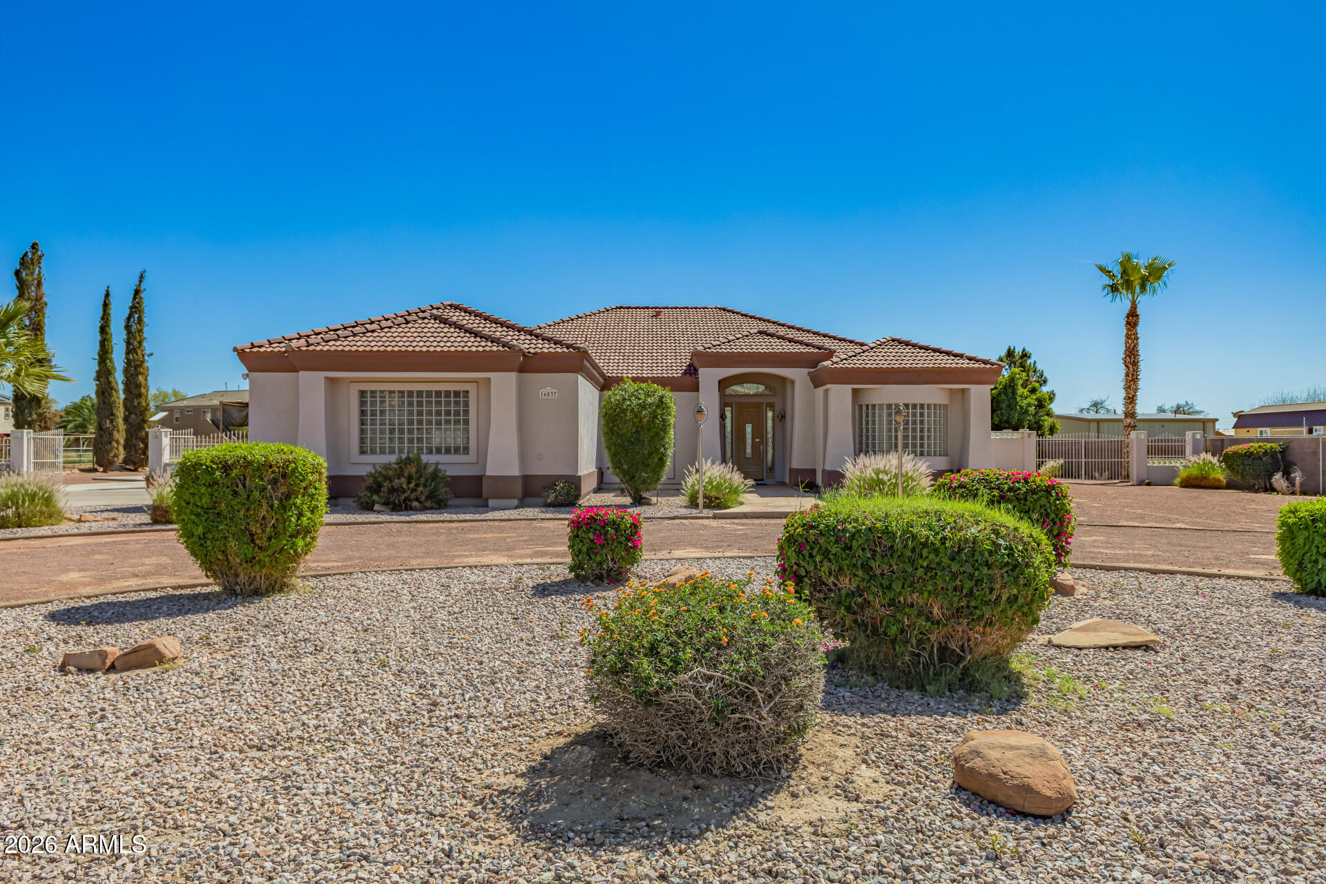 16037 West Wade Lane Goodyear, AZ 85338 - Photo 3 of 67 a front view of a house with a yard