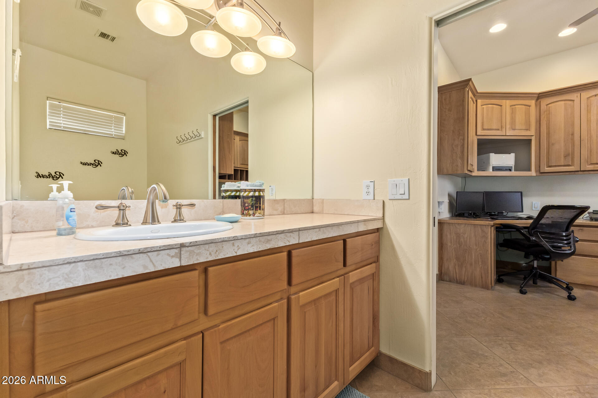 16037 West Wade Lane Goodyear, AZ 85338 - Photo 39 of 67 a spacious bathroom with a double vanity sink and a mirror