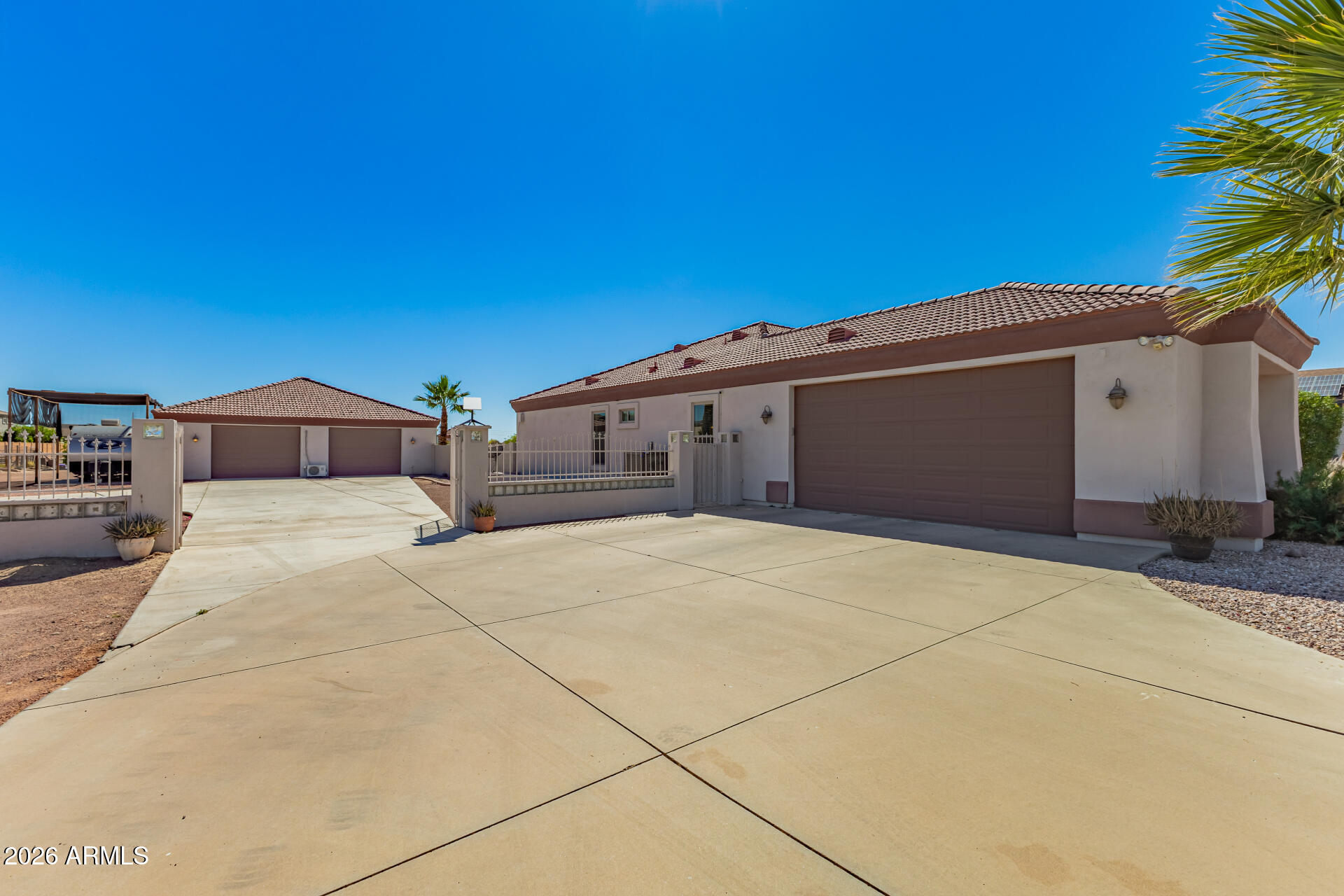 16037 West Wade Lane Goodyear, AZ 85338 - Photo 50 of 67 a front view of a house with a yard