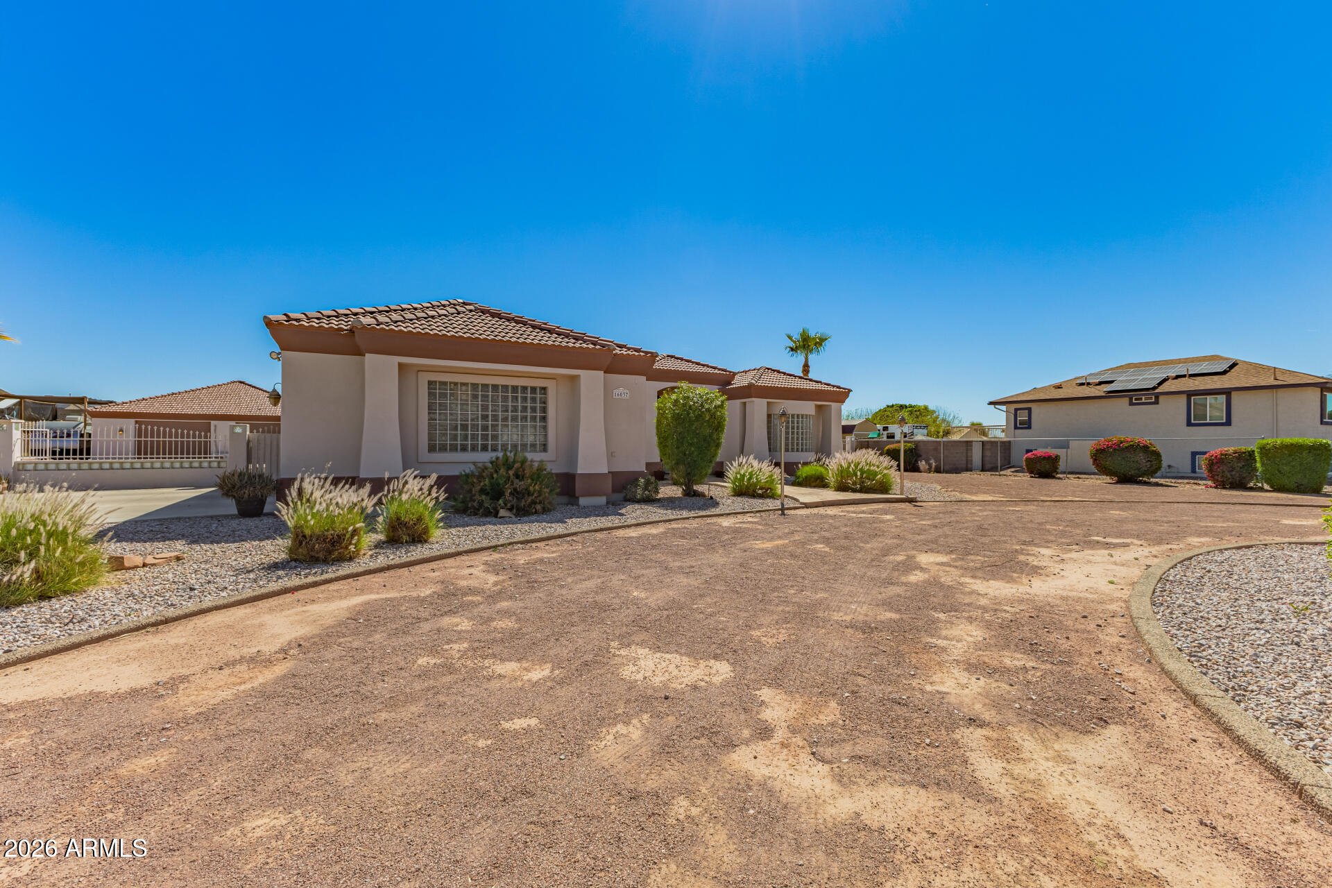 16037 West Wade Lane Goodyear, AZ 85338 - Photo 5 of 67 a front view of a house with garden
