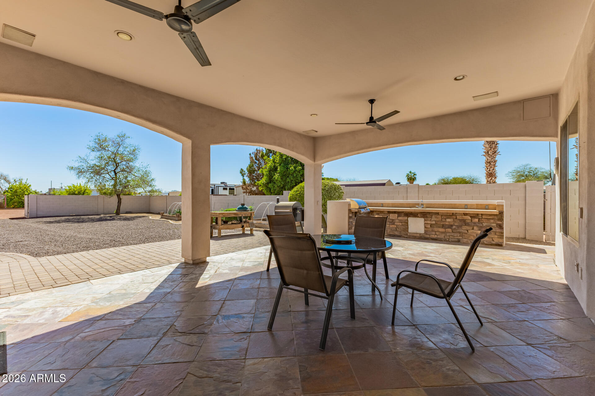 16037 West Wade Lane Goodyear, AZ 85338 - Photo 53 of 67 a view of a patio with a table and chairs