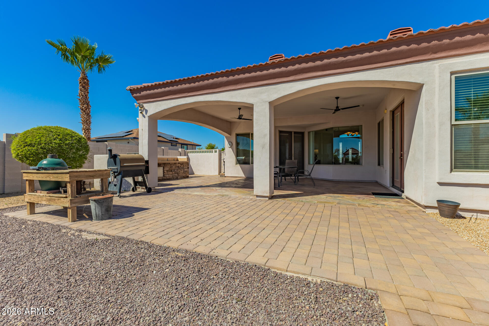 16037 West Wade Lane Goodyear, AZ 85338 - Photo 56 of 67 front view of a house with potted plants