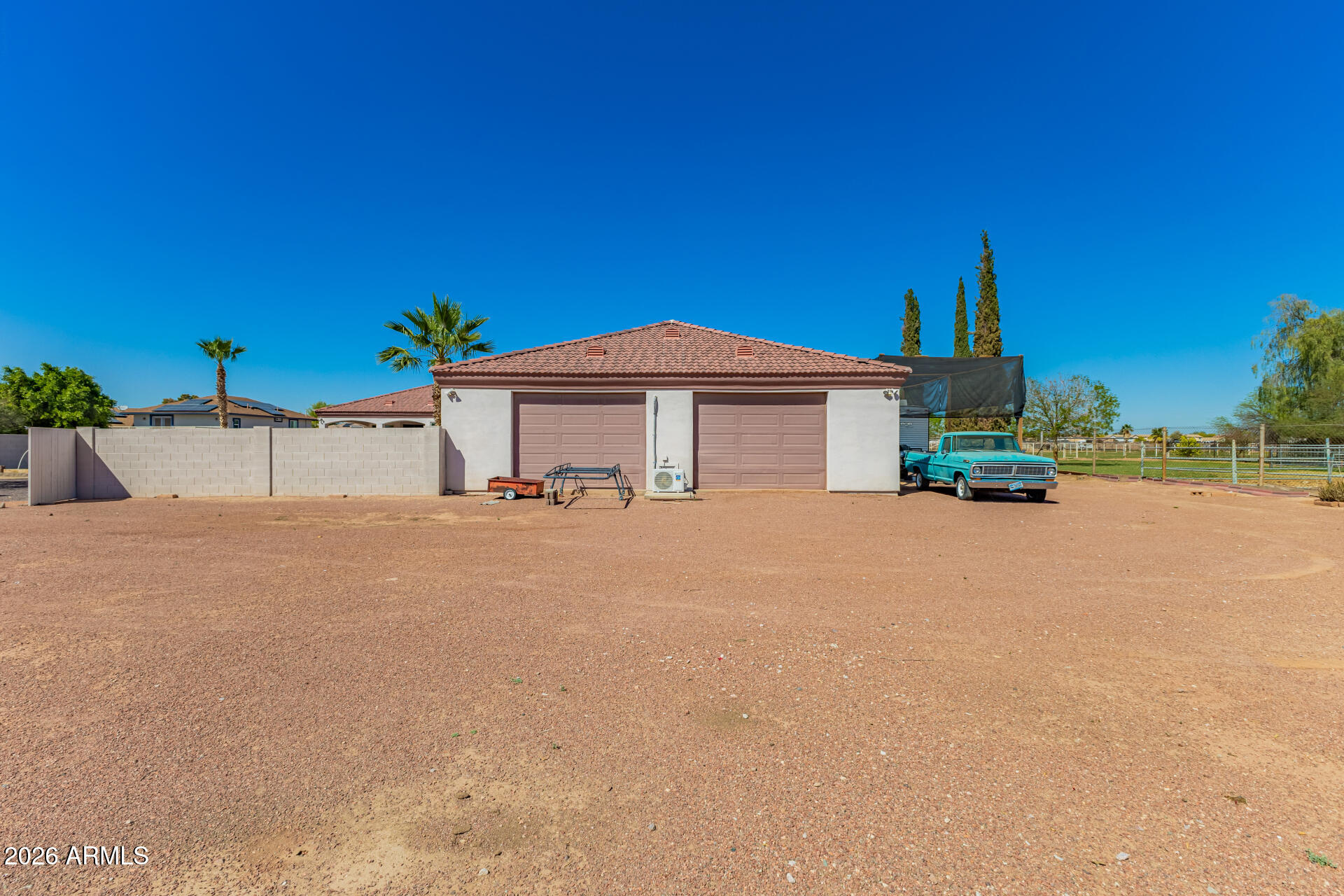 16037 West Wade Lane Goodyear, AZ 85338 - Photo 66 of 67 a house with a yard and a large parking space