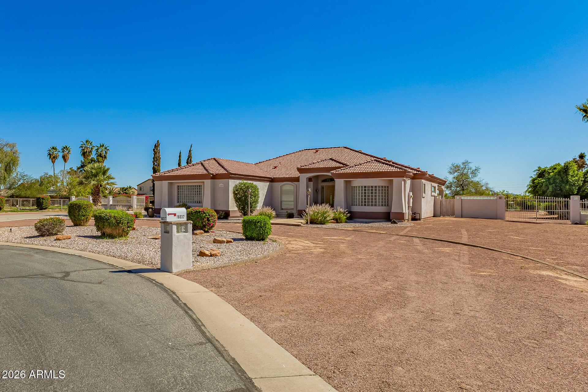 16037 West Wade Lane Goodyear, AZ 85338 - Photo 7 of 67 a front view of a house with a yard