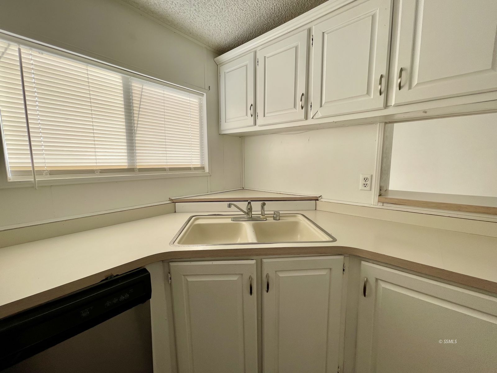 1465 Pony Street Ridgecrest, CA 93555 - Photo 28 of 32 a kitchen with white cabinets and a sink