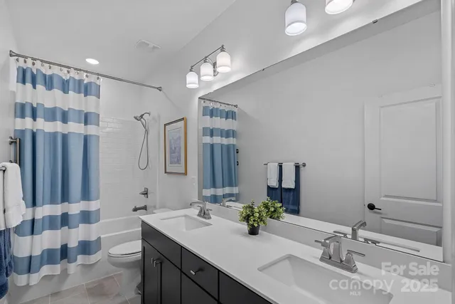 a bathroom with a double vanity sink mirror and double