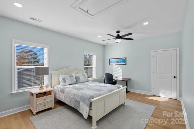 a bedroom with a bed and a ceiling fan