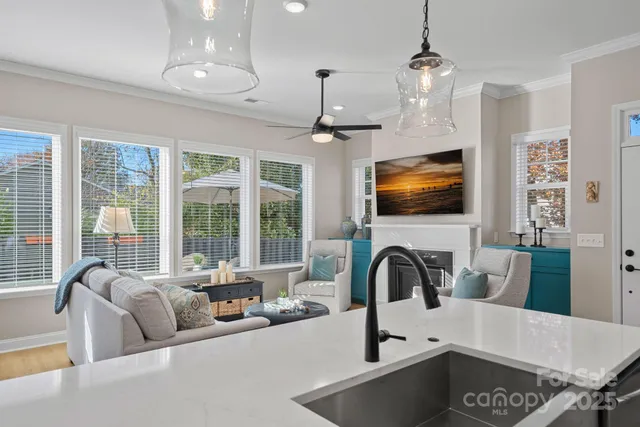 a view of a kitchen with a sink and a dining table wooden floor