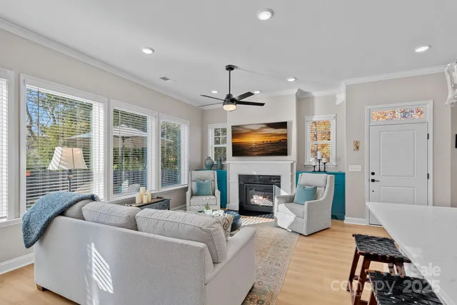 a living room with furniture a flat screen tv and a fireplace