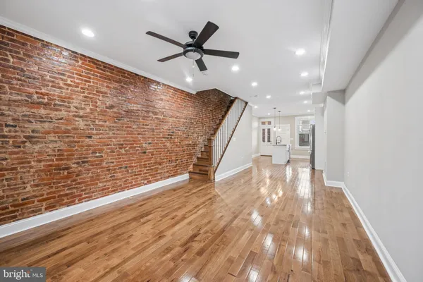 a view of empty room with wooden floor