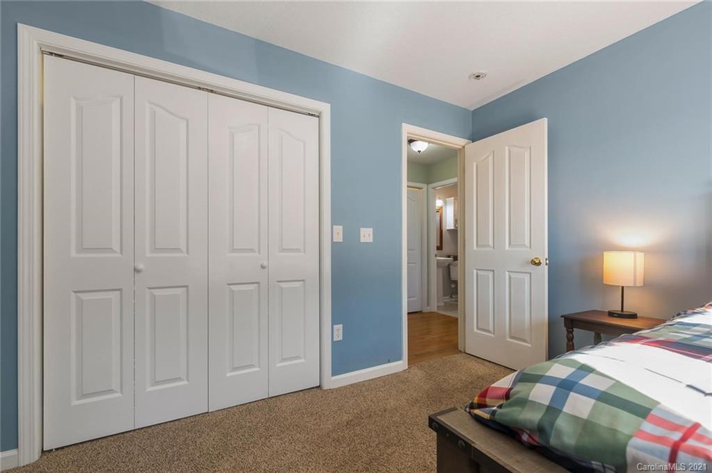 54 Souther Road Fletcher, NC 28732 - Photo 22 of 40 a bedroom with a bed and a lamp