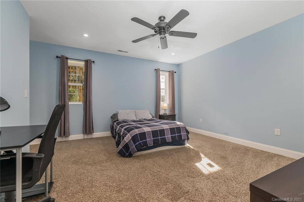 54 Souther Road Fletcher, NC 28732 - Photo 29 of 40 a spacious bedroom with a bed and a ceiling fan