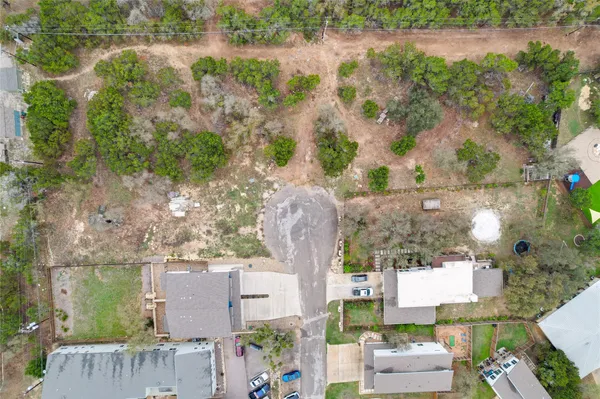 an aerial view of a house with outdoor space and lake view