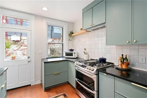 a kitchen with a sink stove and cabinets