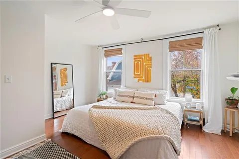 a bedroom with a bed and a window