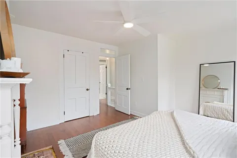 a bedroom with a bed and a mirror