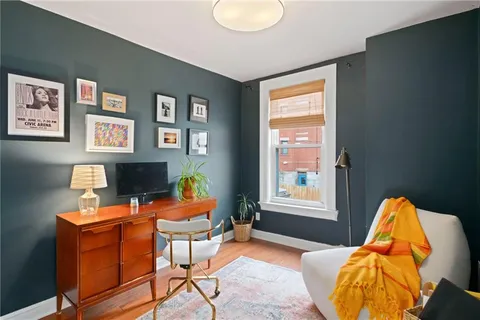 a bedroom with furniture and a window