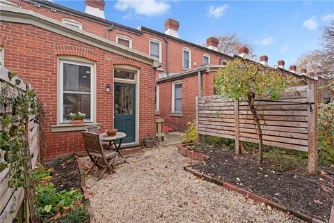 a view of a house with a yard and sitting area