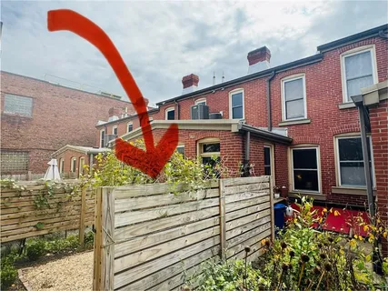 a view of a patio with table and chairs with wooden fence and plants