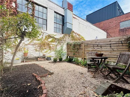 a front view of a house with outdoor seating