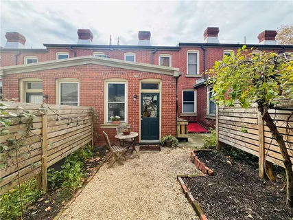 a front view of a house with a garden