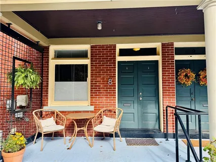 a view of a chairs and table in the back of the house