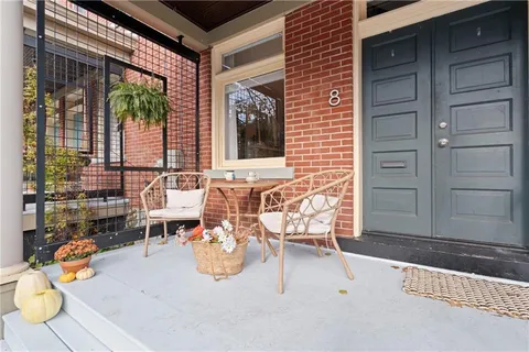 a view of a house with a yard and wooden fence